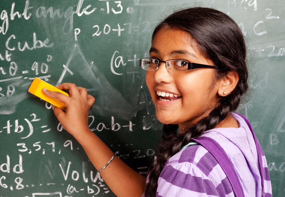 Student wearing eyeglasses at blackboard