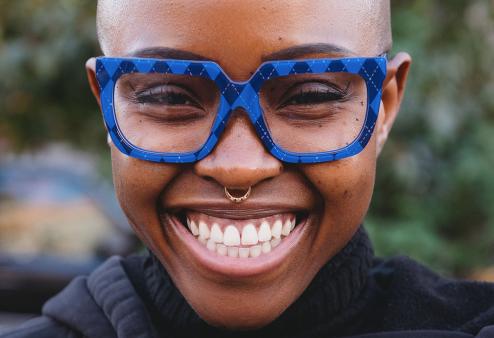 Smiling Black woman wearing Official by Vontelle Douglass frames for America's Best