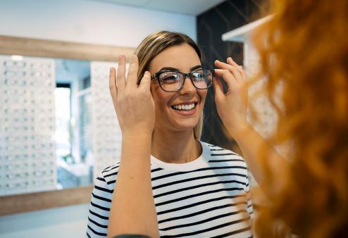 Young adult female trying on glasses