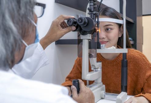 Young adult female getting an eye exam