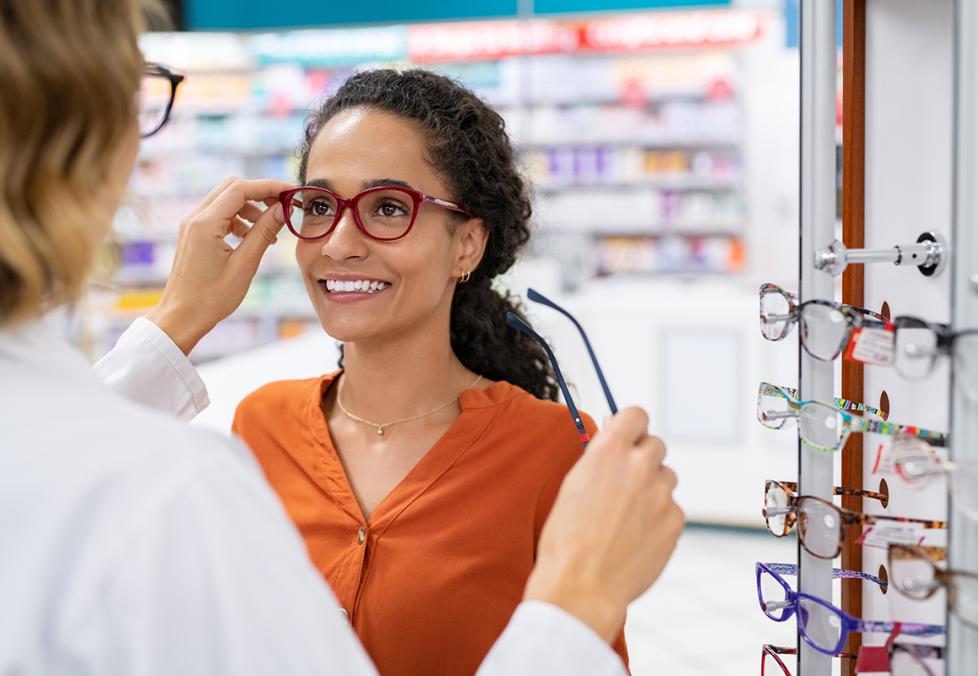 A young woman trying on glasses at a store