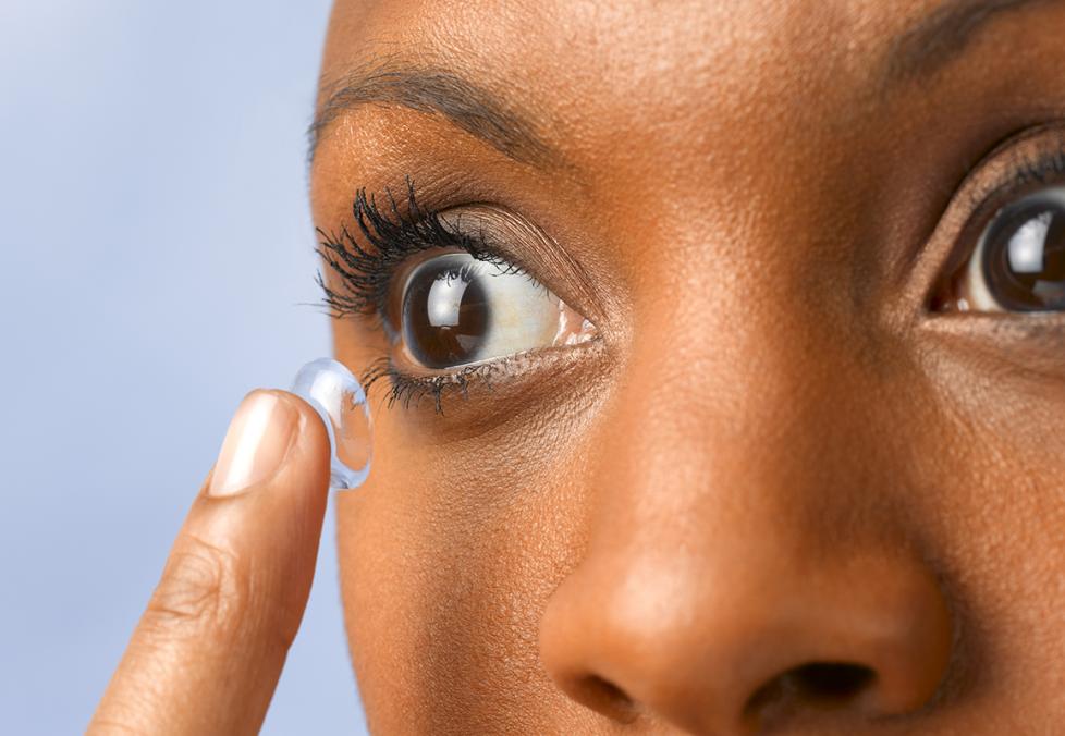 Person putting on contact lenses