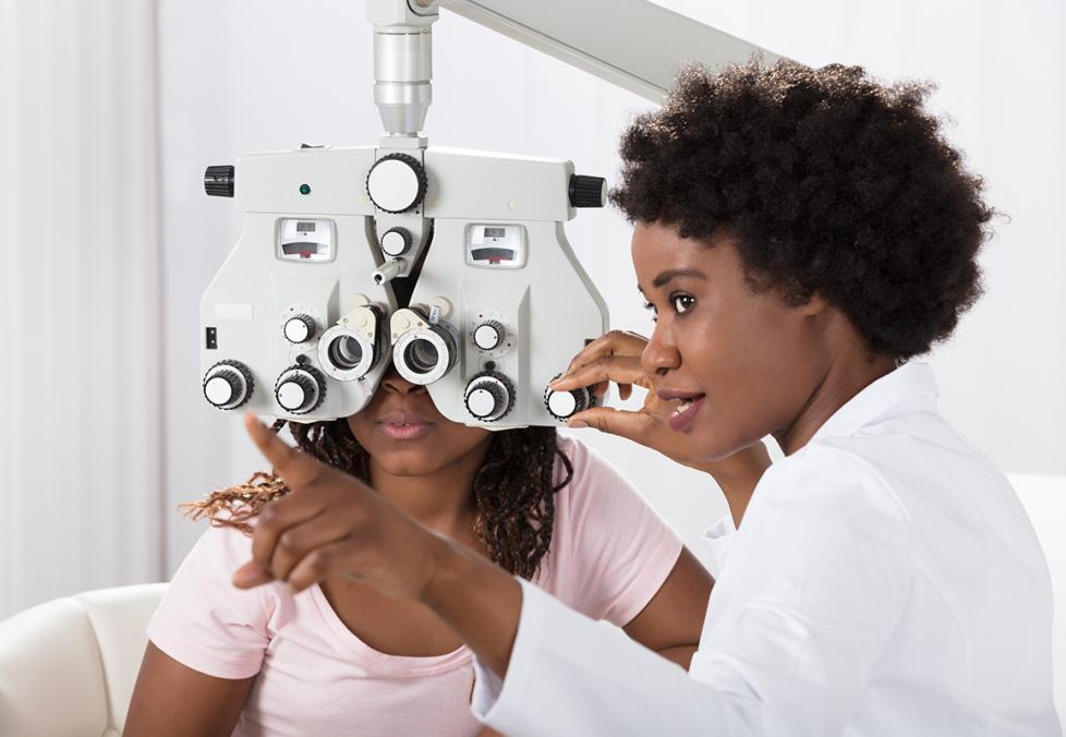 Optometrist performing eye test