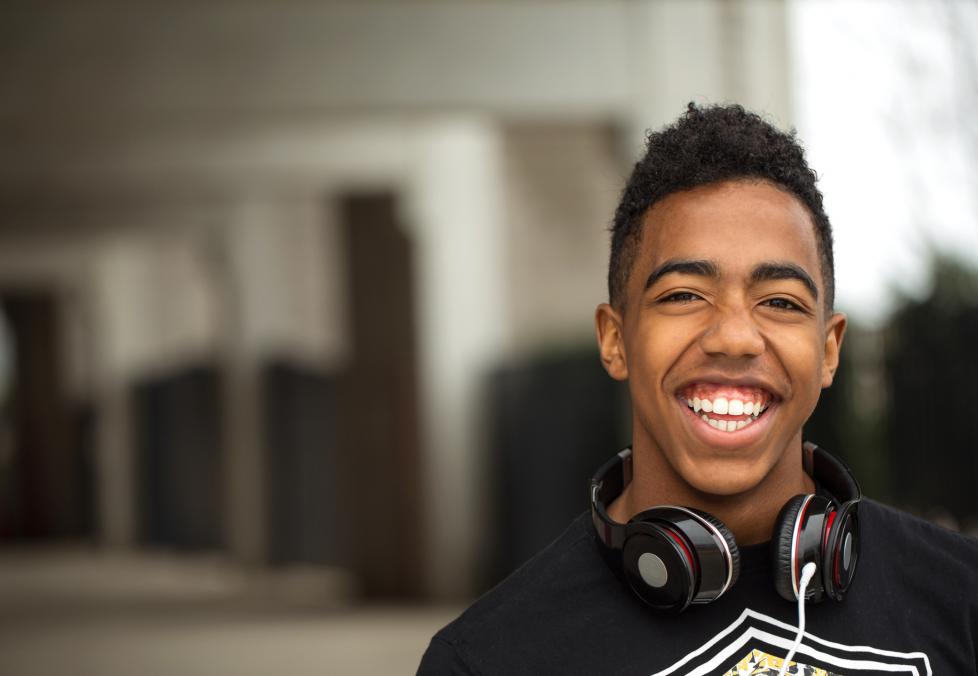Smiling young adult with headphones