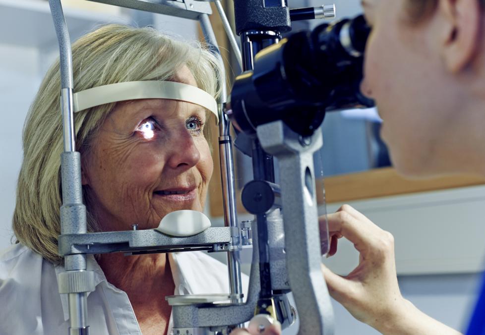 A woman getting an eye exam with her optometrist.