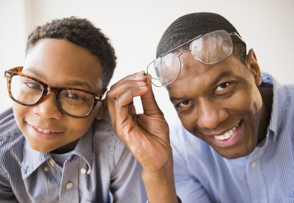 Son and father wearing glasses.