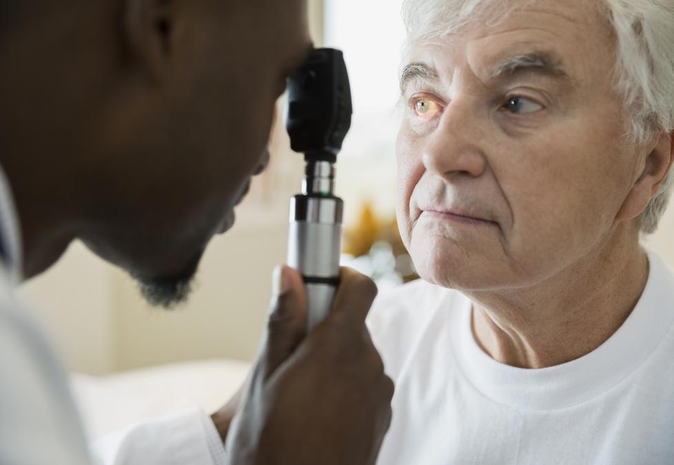 Regular eye exams are important for diabetes. Older man getting eyes checked.
