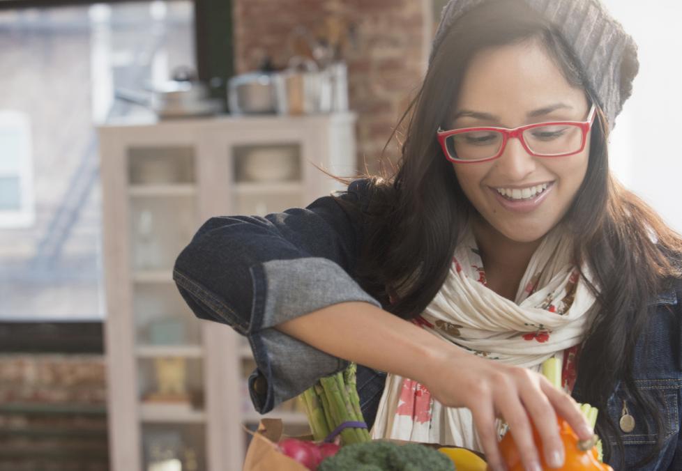 A young woman wearing glasses shopping for groceries