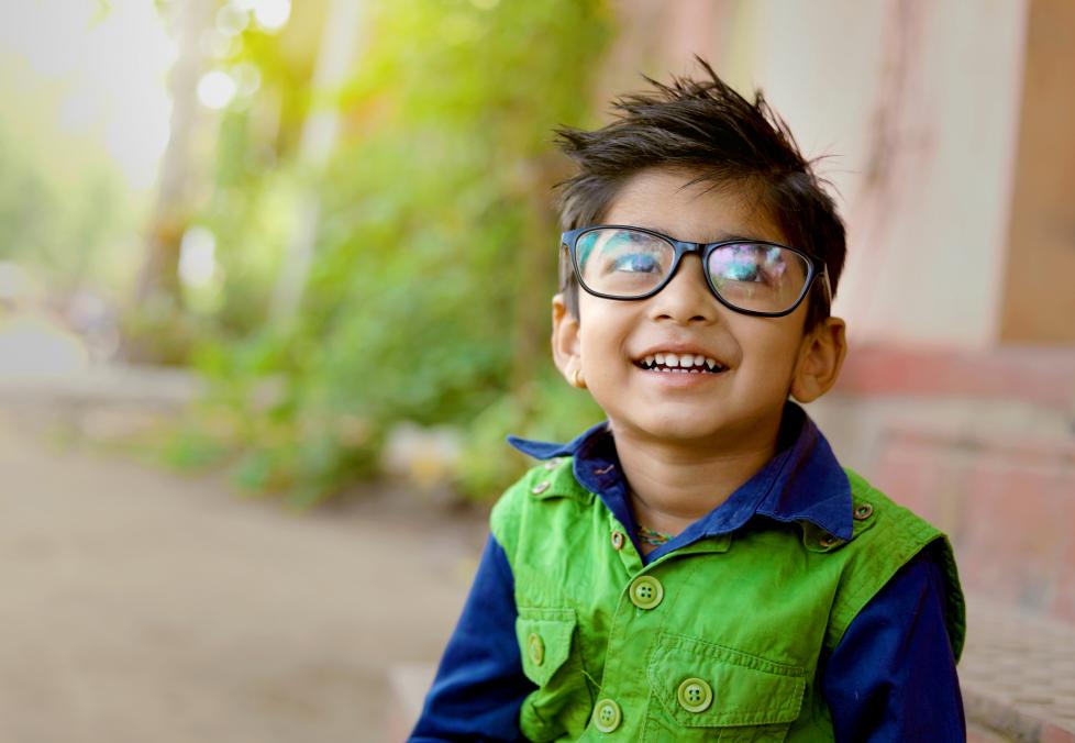 A young boy wearing glasses