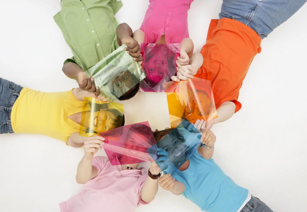 Kids in a circle holding color transparencies.