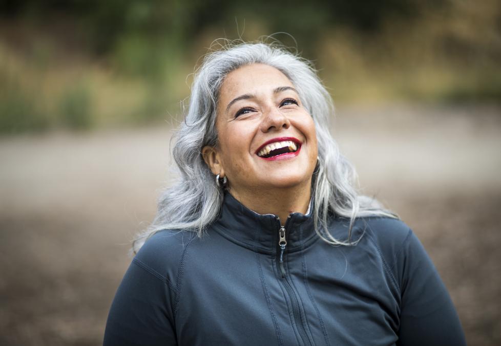 Silver-haired woman smiling.