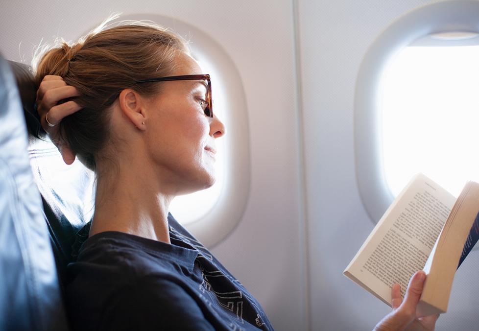 A woman reading on a plane