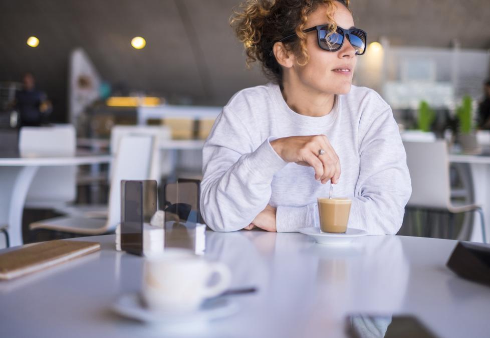 Woman in a cafe wearing sunglasses