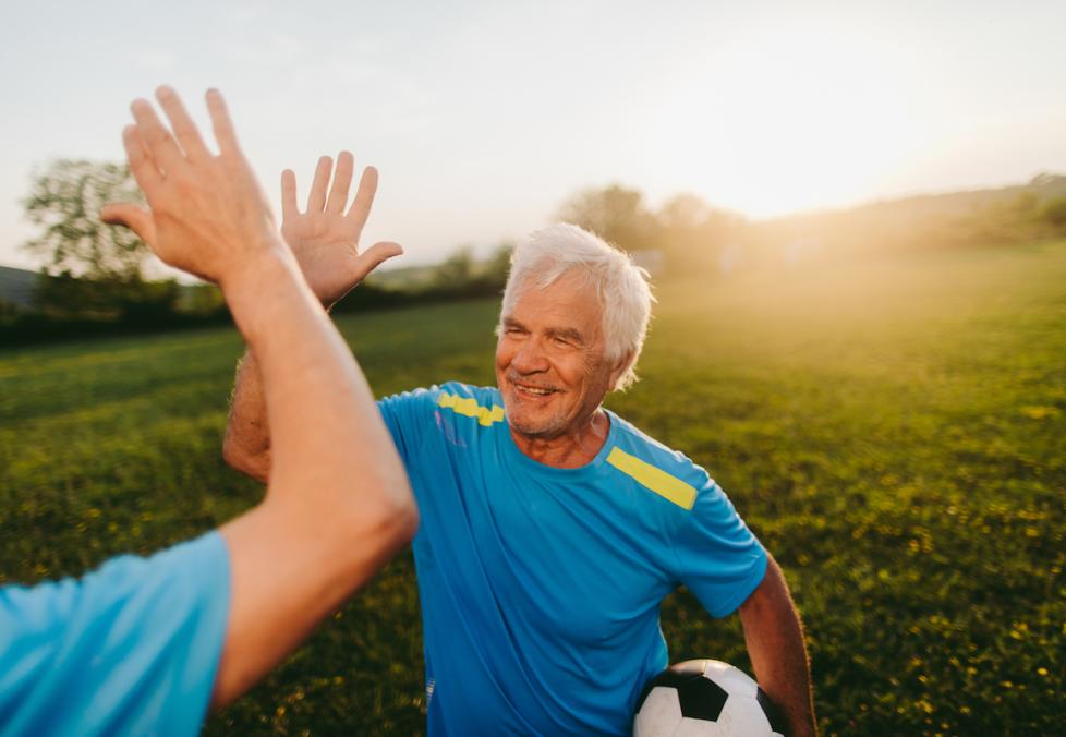 older men playing soccer