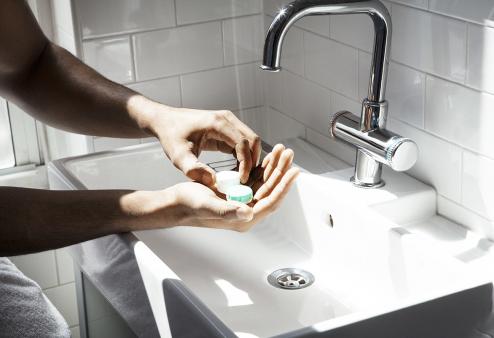 Person washing contact lens