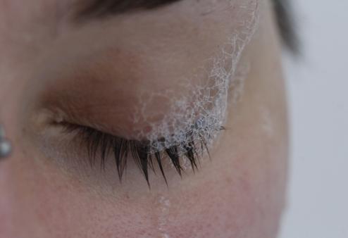 A closeup of someone's face with soap in their eye