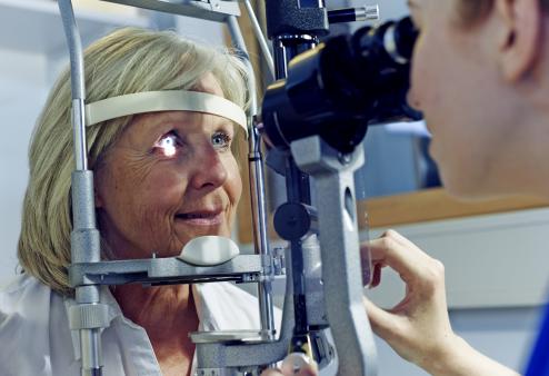 A woman getting an eye exam with her optometrist.