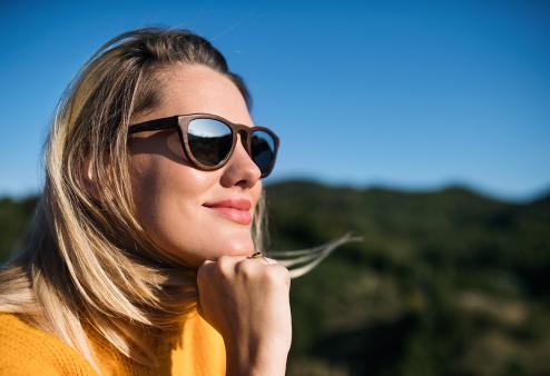 Woman wearing sunglasses outdoors smiling