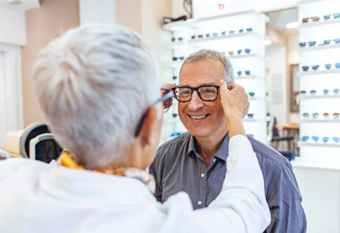 Senior women putting glasses on senior man