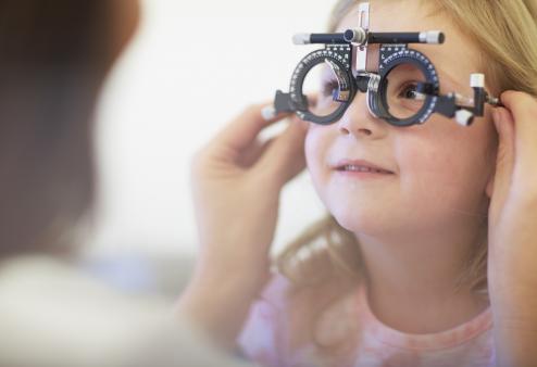 Young girl getting an eye exam.
