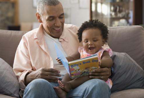 Contact lens options for presbyopia. Man reading to baby.