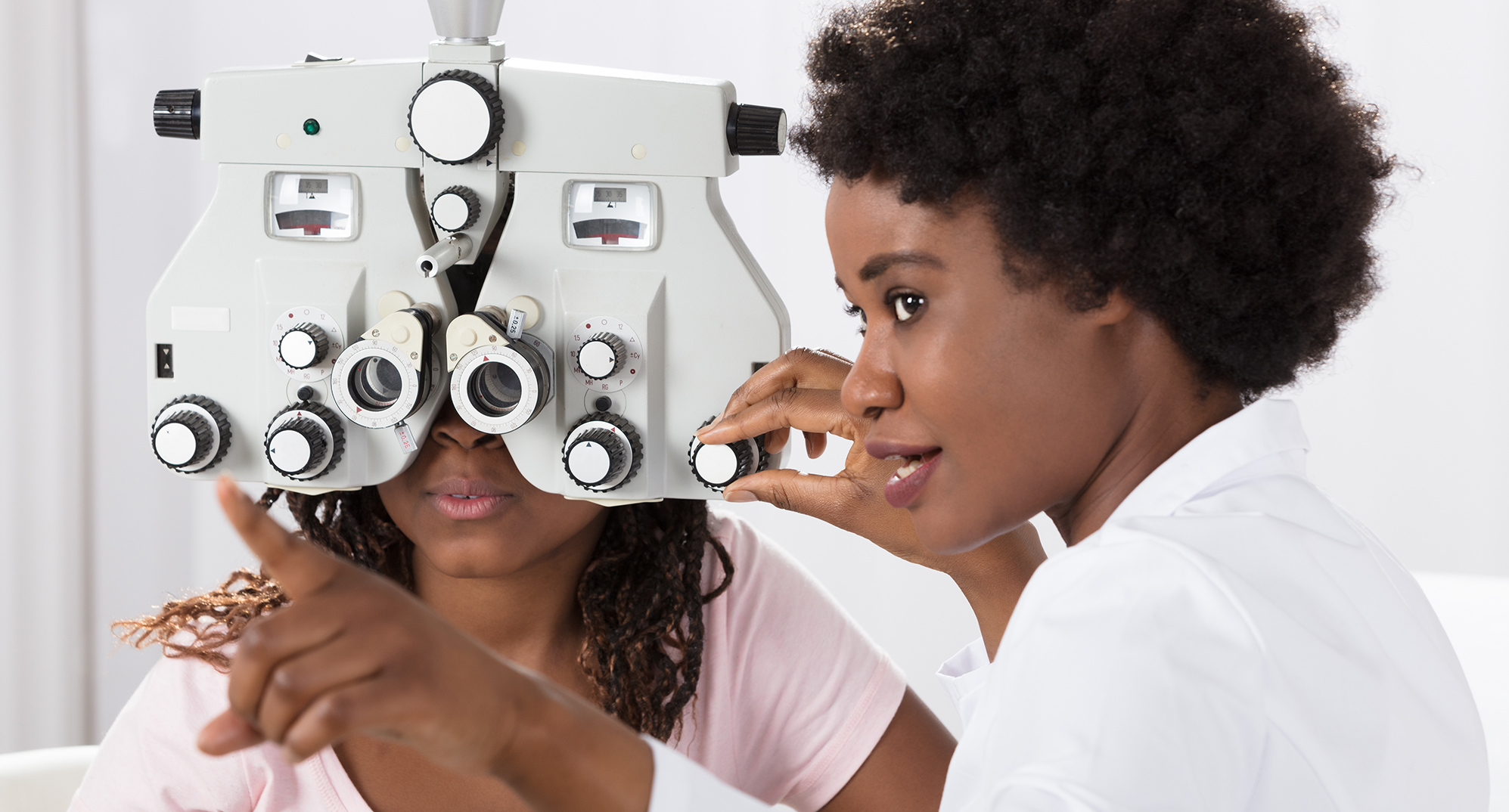Female optometrist administering eye exam