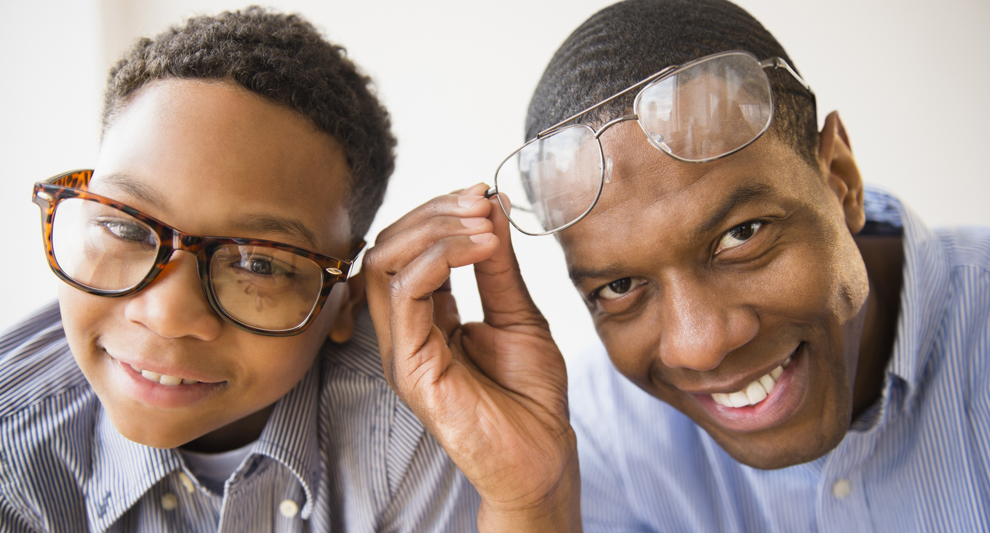 Son and father wearing glasses.